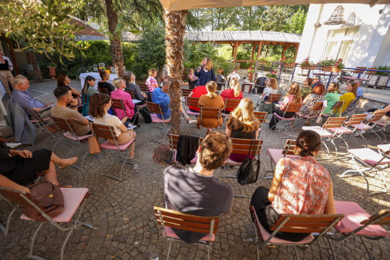 Maja Nenadovic speaking in a circle of seated participants at Exploring "BORDERS": A preview of the NECE Festival 2024 in Tirana