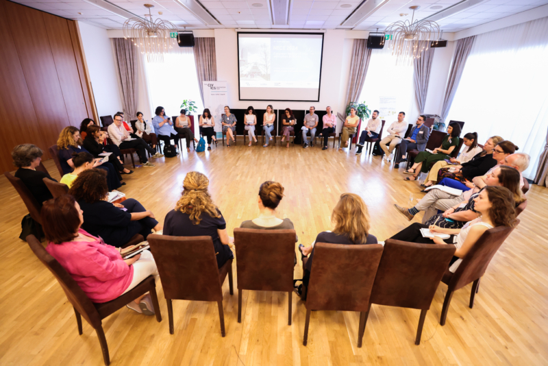 A conference room with participants seating in a circle of chairs at the Exploring "BORDERS": A preview of the NECE Festival 2024 in Tirana