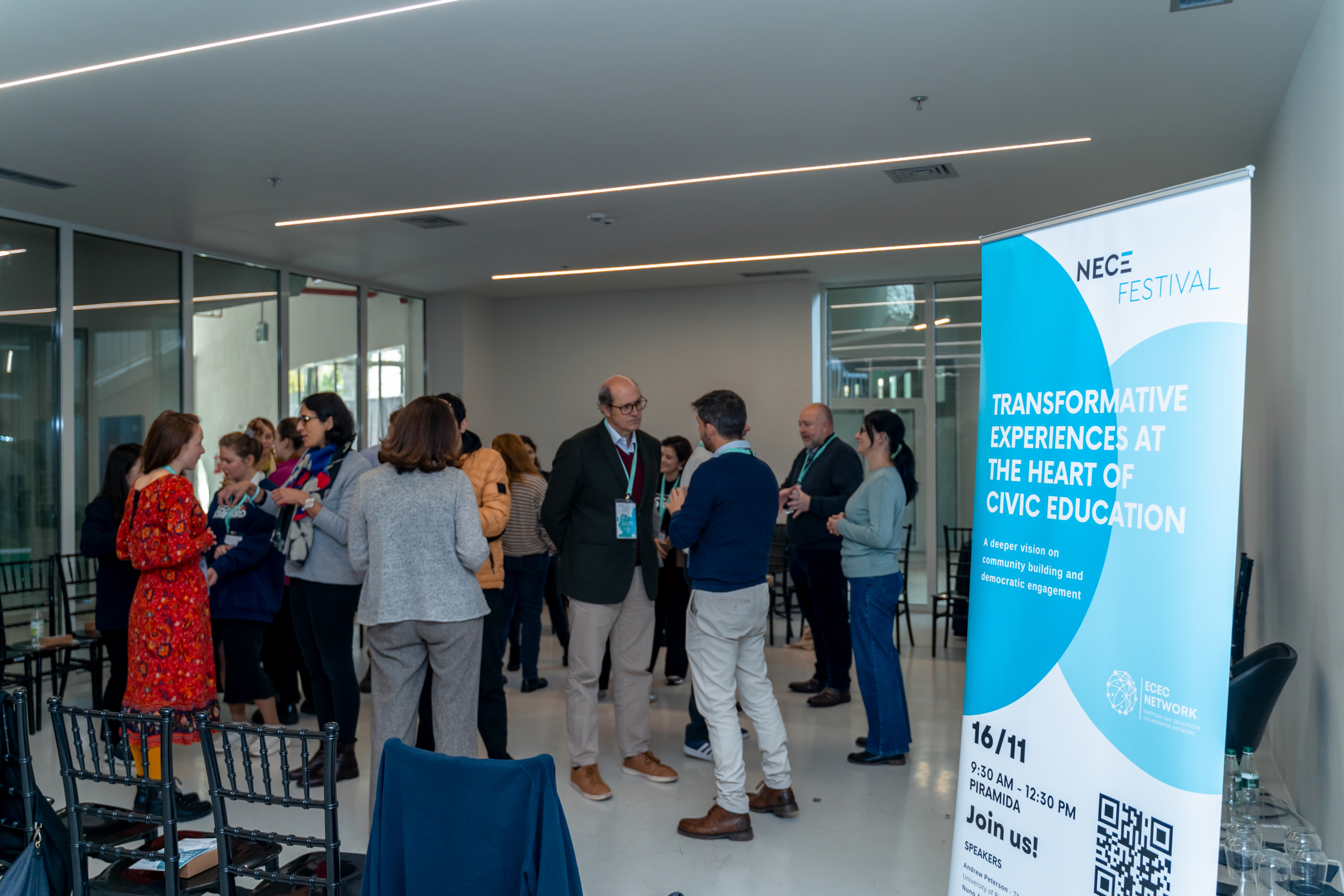 © THE CIVICS Innovation Hub | Geri Lula Group of people engage in conversation at NECE Festival 2024. A prominent banner reads "Transformative Experiences at the Heart of Civic Education."