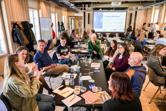 © THE CIVICS Innovation Hub / Werner Anderson The picture shows the NECE Prep Lab: Hope as a civic skill. Participants are sitting on different group tables for reflecting the previous inputs.