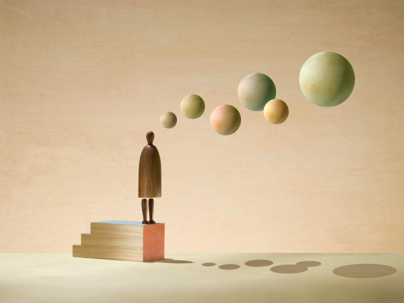 The image shows a wooden person and wooden bubbles above it.