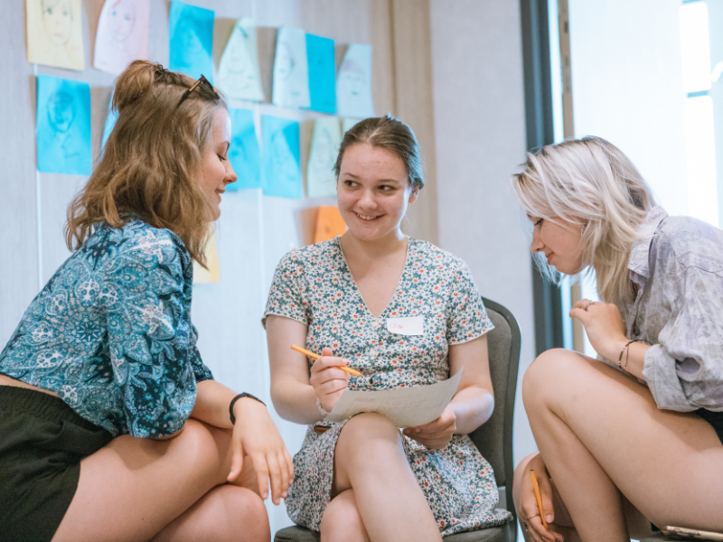 A picture of three young women talking